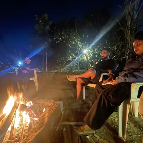 The group gathered close around the bonfire after dark.