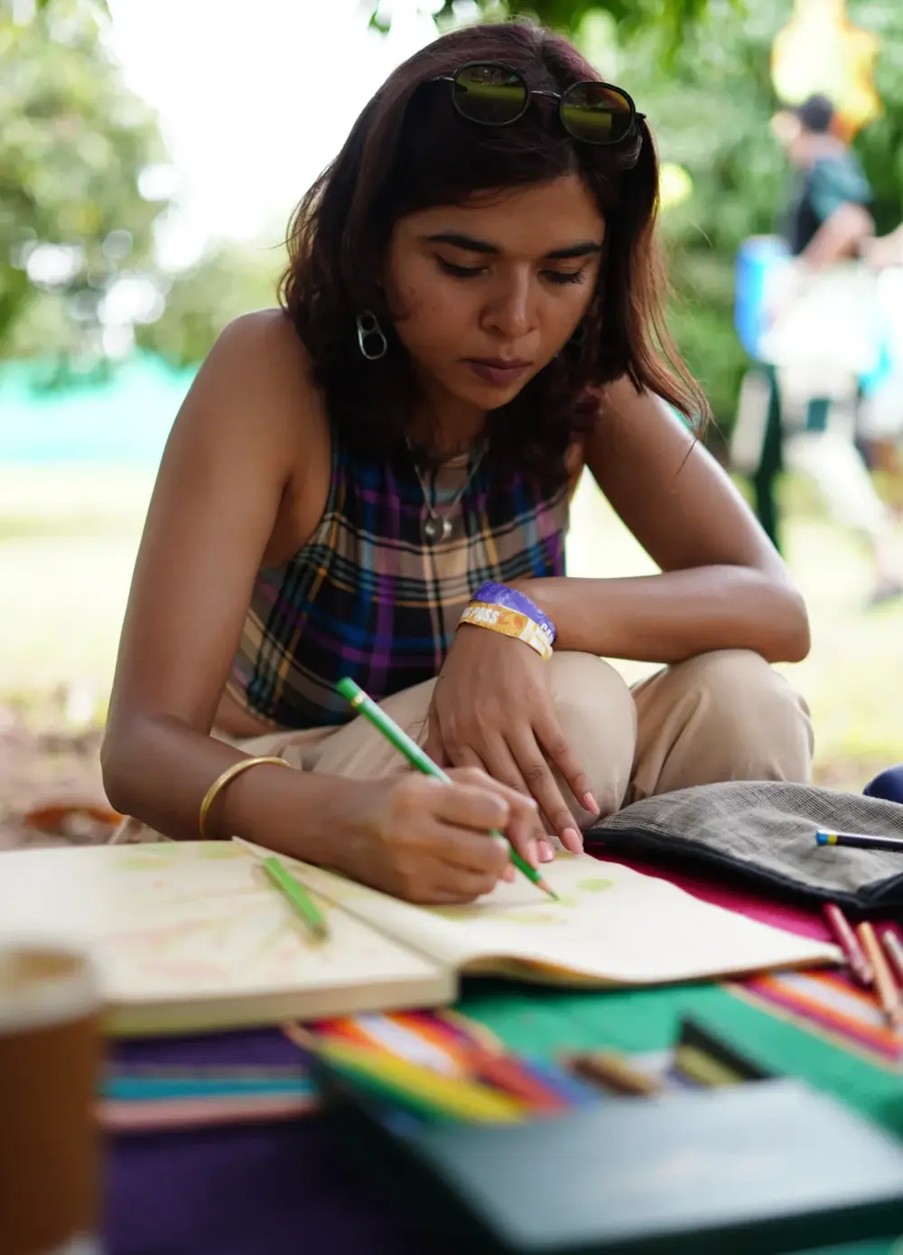 Deep focus work outdoors, pen and paper under the trees.