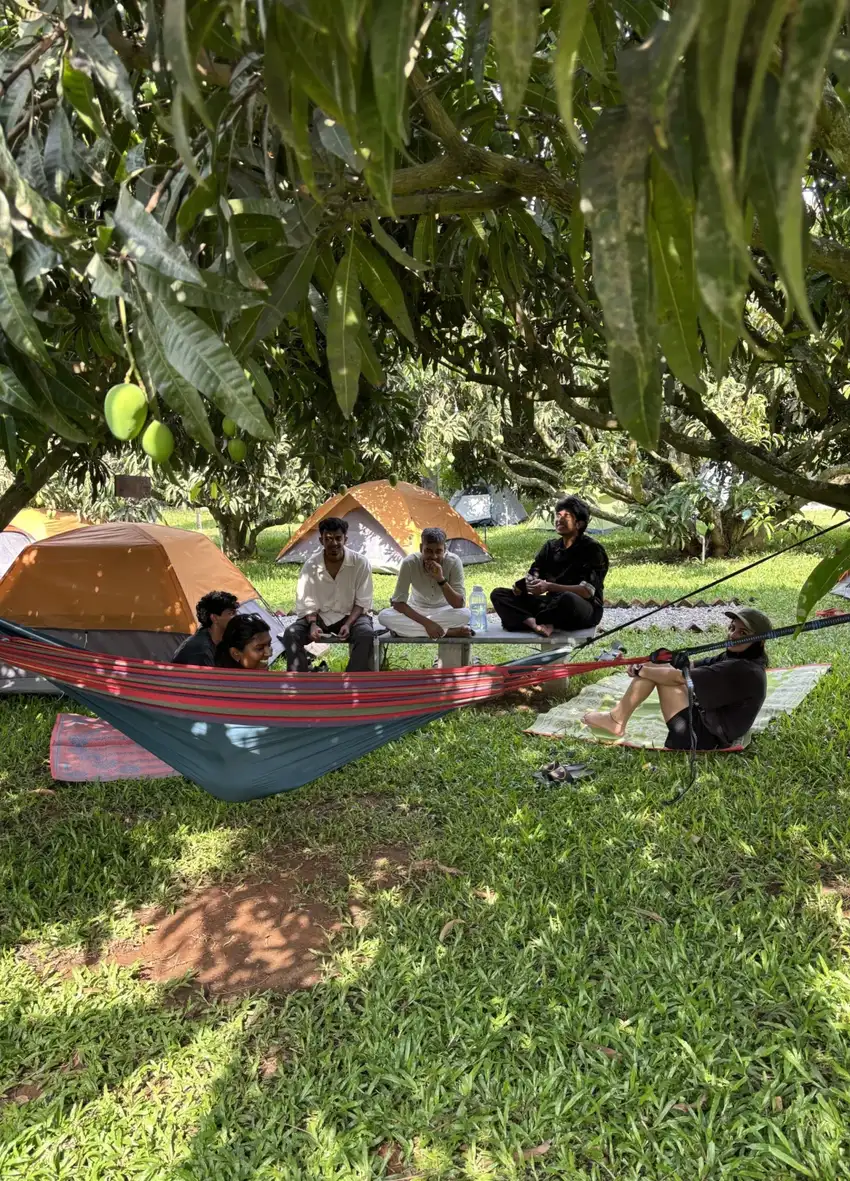 A hammock break in the shade, tents pitched close by.